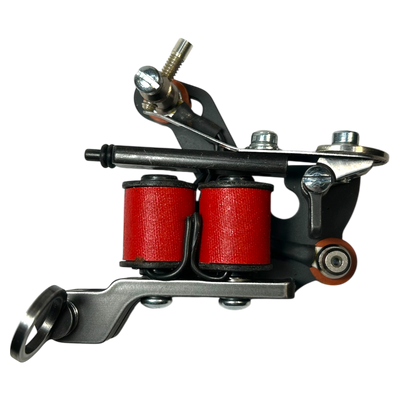 Hatchback traditional coil tattoo machine with red wrap coils and steel frame